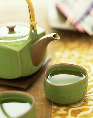 Teapot and cup with green tea